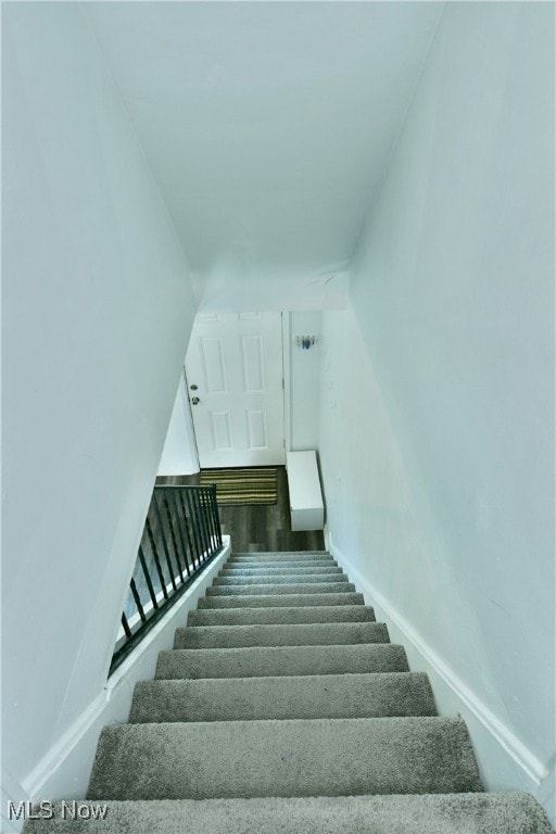 stairs featuring hardwood / wood-style floors