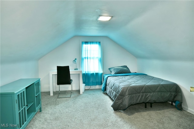 bedroom featuring lofted ceiling and carpet flooring