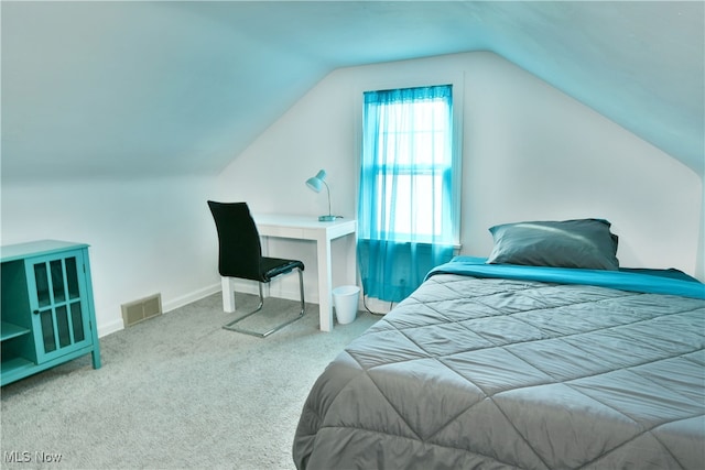 carpeted bedroom featuring vaulted ceiling