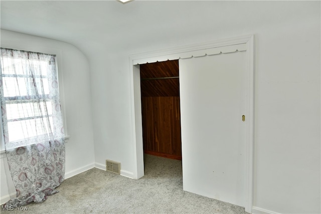 unfurnished room featuring light colored carpet