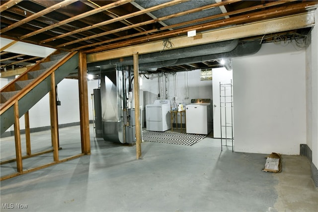 basement with heating unit and washer and clothes dryer