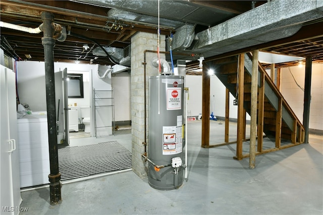 basement with water heater and washer / clothes dryer