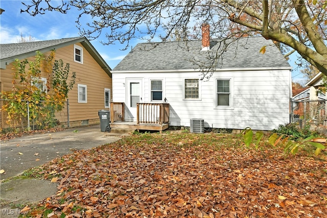 rear view of property with central AC