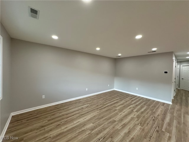 unfurnished room with light wood-type flooring