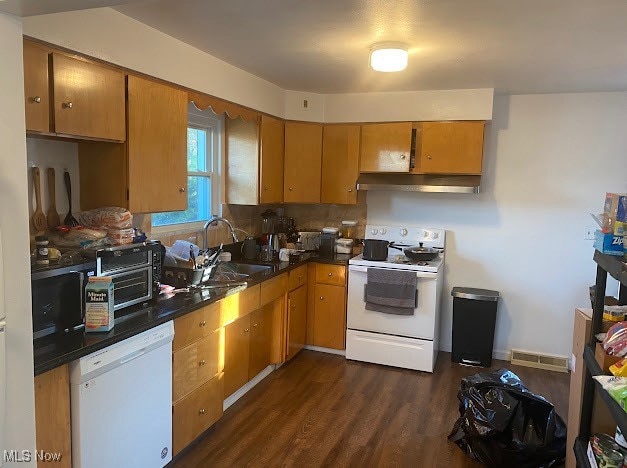 kitchen with white appliances, dark hardwood / wood-style floors, and sink