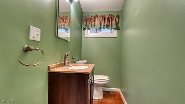 bathroom featuring hardwood / wood-style floors, vanity, and toilet