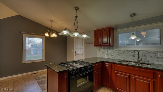 kitchen with backsplash, pendant lighting, black range with gas stovetop, sink, and lofted ceiling