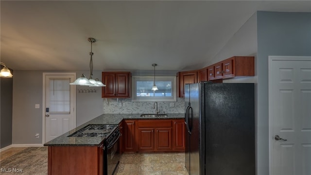 kitchen with black appliances, hanging light fixtures, decorative backsplash, sink, and dark stone countertops