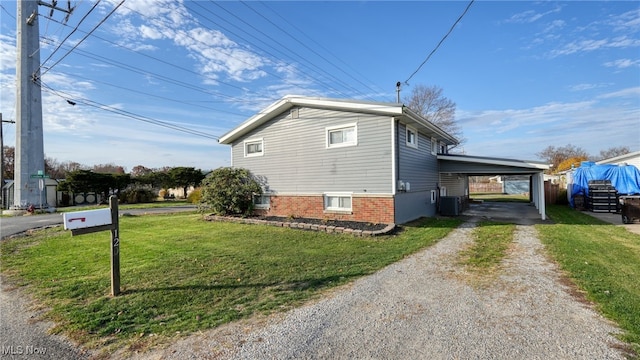 view of side of property with central AC, a lawn, and a carport