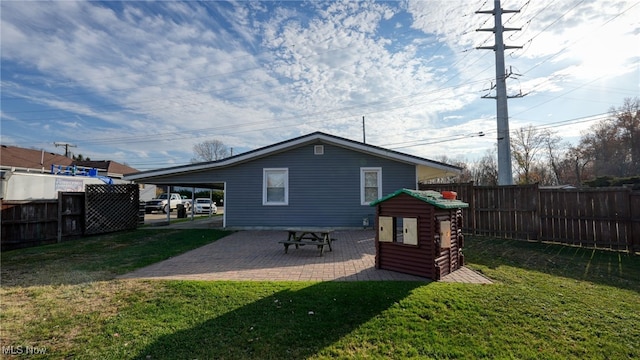 rear view of property with a patio and a yard