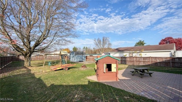 view of yard featuring a patio and a shed