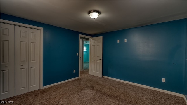 unfurnished bedroom with a closet and carpet flooring