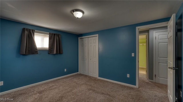 unfurnished bedroom with a closet and carpet