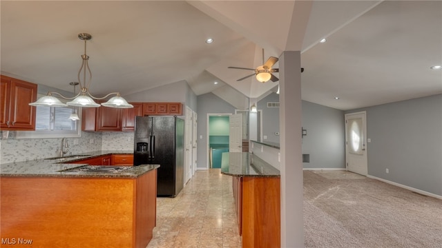 kitchen with light colored carpet, lofted ceiling, kitchen peninsula, decorative backsplash, and black fridge with ice dispenser