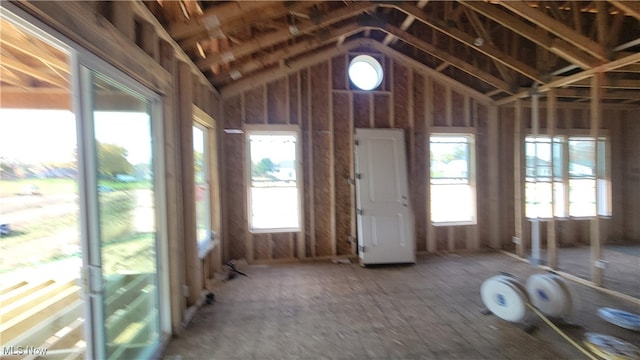 misc room featuring vaulted ceiling and plenty of natural light