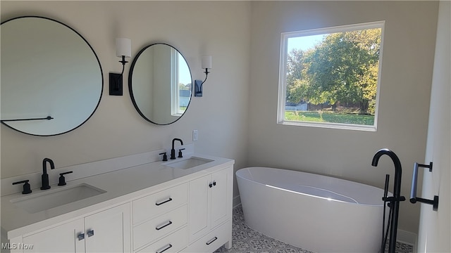 bathroom with vanity and a tub