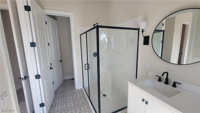 bathroom with vanity and a shower with shower door