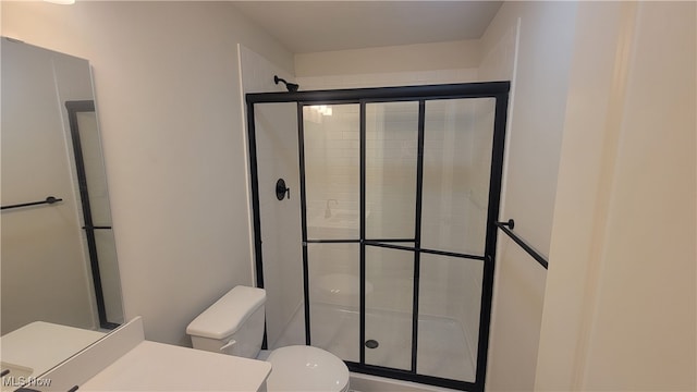 bathroom with walk in shower and toilet