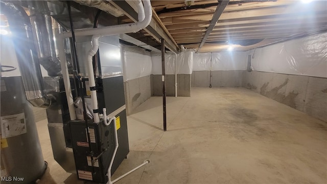 basement with water heater and heating unit