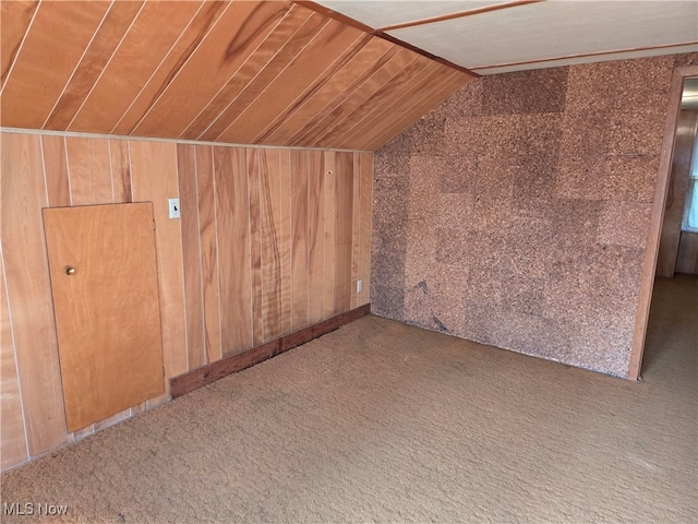 bonus room featuring wood ceiling, wooden walls, lofted ceiling, and carpet flooring