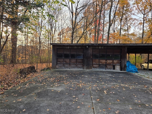 exterior space with a garage and a carport