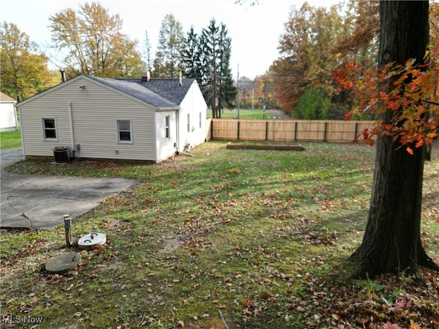 view of yard with central AC unit and a patio area