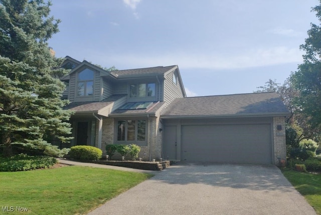 view of front of house with a garage and a front lawn