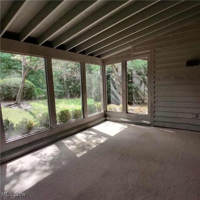 unfurnished sunroom featuring lofted ceiling