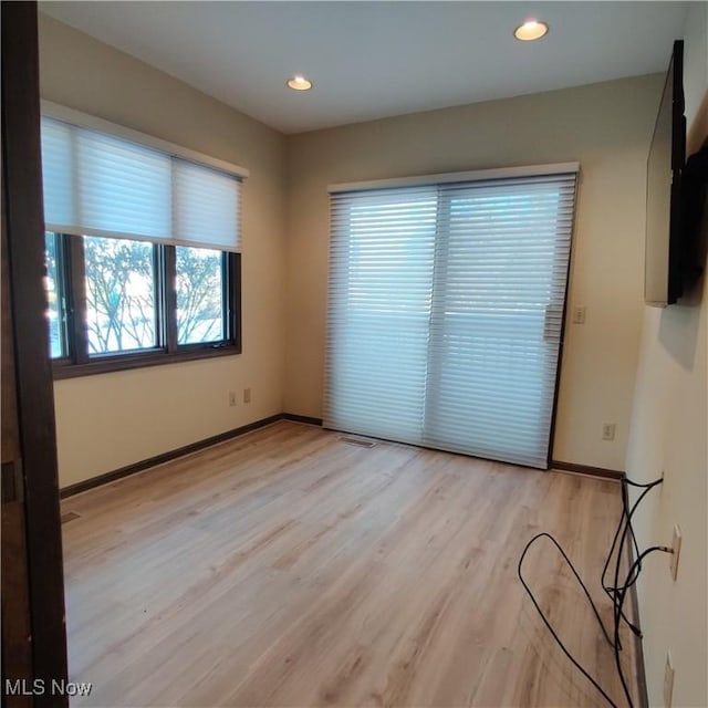 unfurnished room with light wood-type flooring