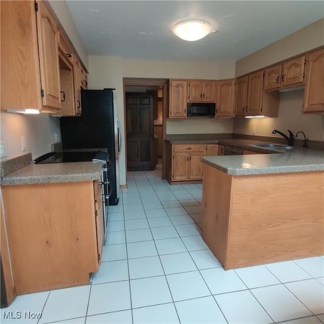 kitchen featuring sink, light tile patterned floors, and stainless steel range with electric cooktop