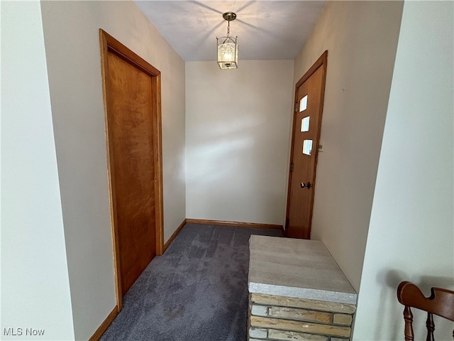 doorway with dark colored carpet