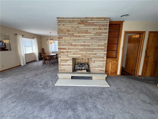 unfurnished living room featuring a brick fireplace and dark colored carpet