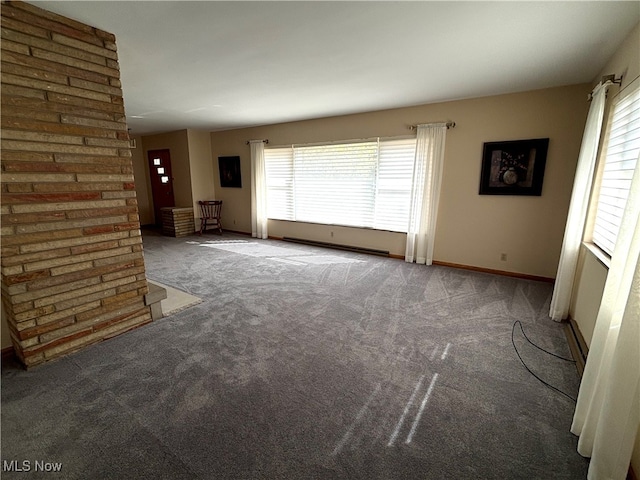 unfurnished living room with dark carpet