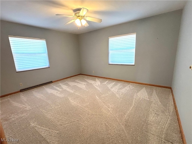 spare room with baseboard heating, carpet, and ceiling fan