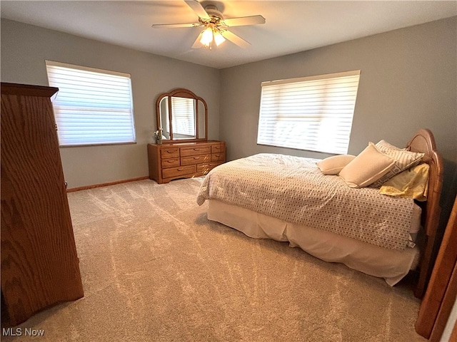 bedroom featuring light colored carpet and ceiling fan