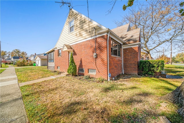 view of side of home with a lawn