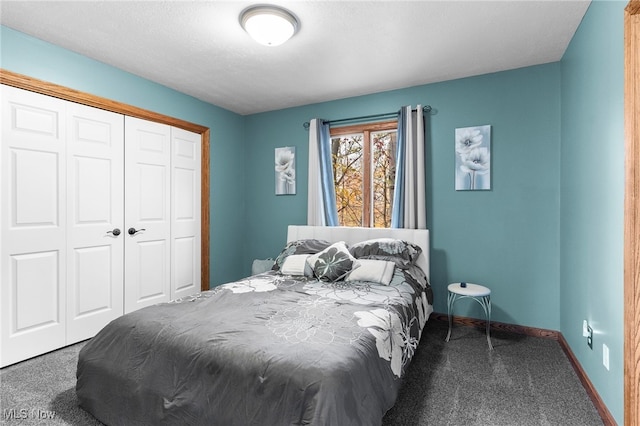 carpeted bedroom featuring a textured ceiling and a closet