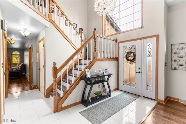 370 Wilcox Rd, Austintown, OH 44515 - tiled foyer entrance featuring stairway, a chandelier, baseboards, and a high ceiling