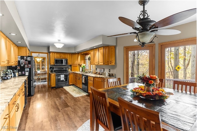 kitchen with black appliances, dark hardwood / wood-style flooring, sink, and ceiling fan