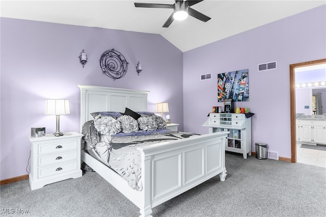 bedroom with vaulted ceiling, light carpet, ceiling fan, and ensuite bath