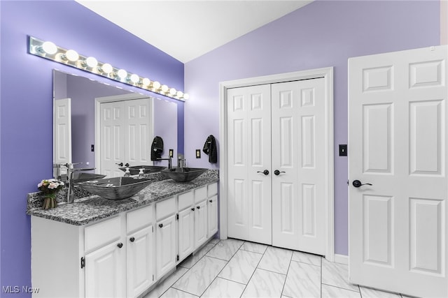 bathroom with vanity and vaulted ceiling