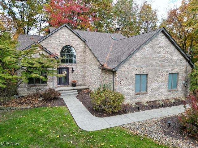 370 Wilcox Rd, Austintown, OH 44515 - french country inspired facade featuring a chimney, brick siding, roof with shingles, and a front yard