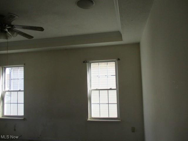 unfurnished room featuring plenty of natural light and ceiling fan