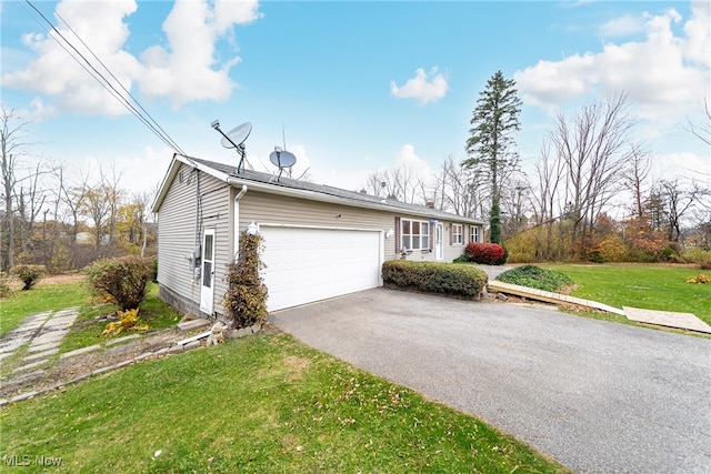 view of home's exterior with a garage and a lawn