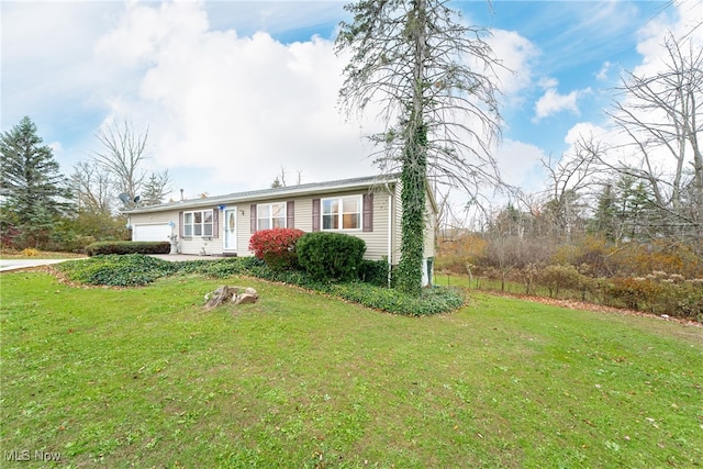 view of front of house with a front lawn and a garage