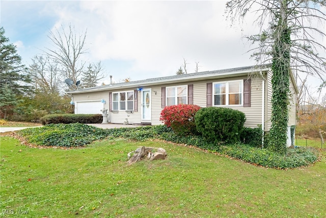 single story home with a garage and a front lawn