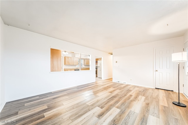 spare room with light hardwood / wood-style flooring