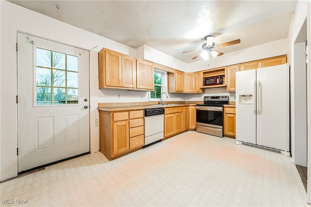 kitchen with plenty of natural light, sink, white appliances, and ceiling fan