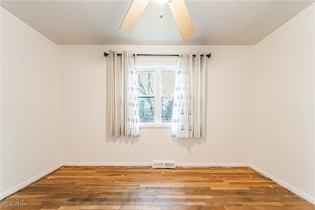 empty room featuring wood-type flooring and ceiling fan