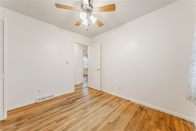 spare room featuring light wood-type flooring and ceiling fan